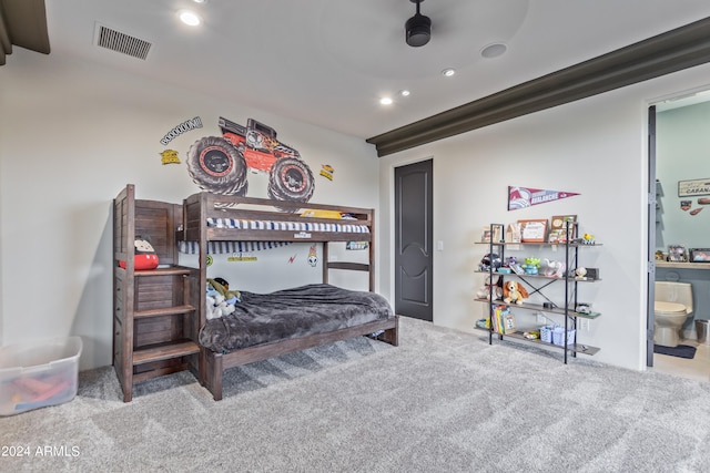 bedroom with light colored carpet, ceiling fan, and ensuite bathroom