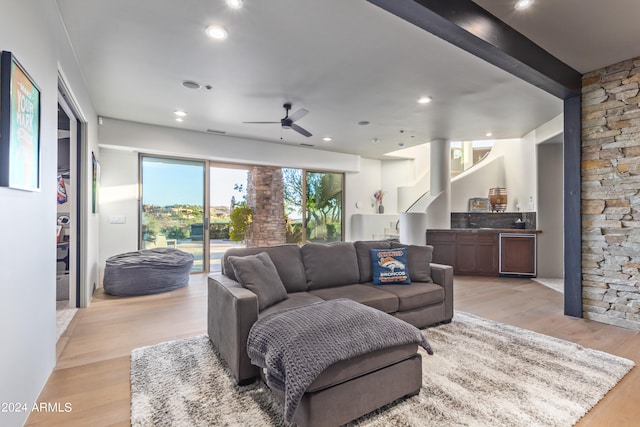 living room with wine cooler, light hardwood / wood-style floors, and ceiling fan