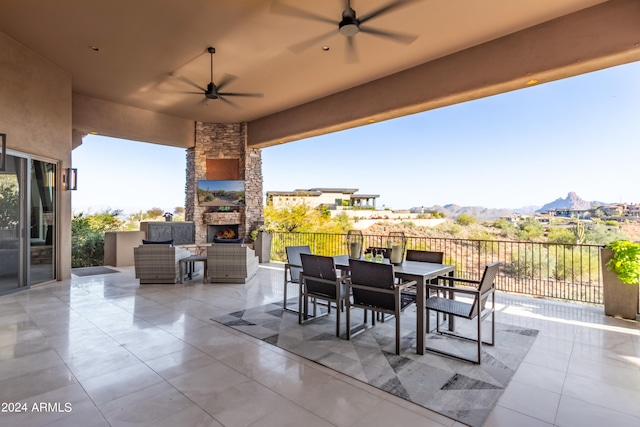 view of patio / terrace featuring ceiling fan, a mountain view, and an outdoor kitchen