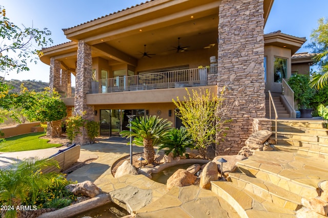 back of property featuring a balcony, a patio, and ceiling fan