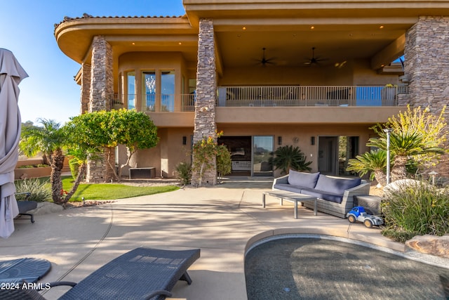 exterior space with outdoor lounge area, a balcony, and ceiling fan