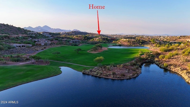 birds eye view of property with a water and mountain view