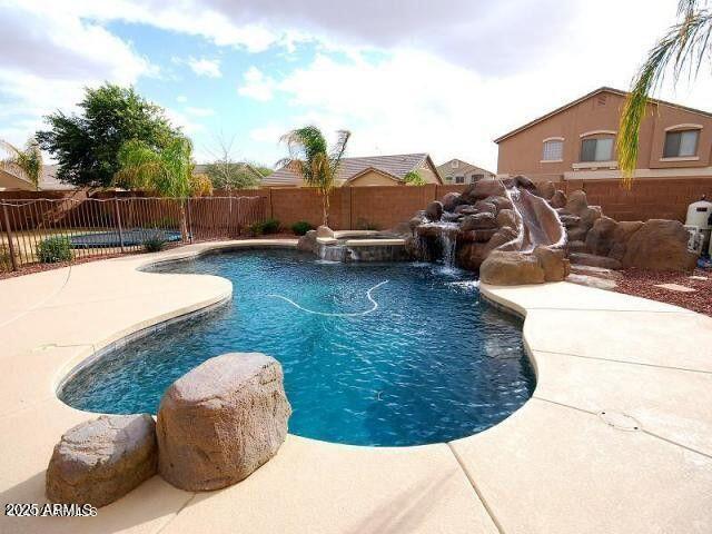 view of pool with a patio and an in ground hot tub