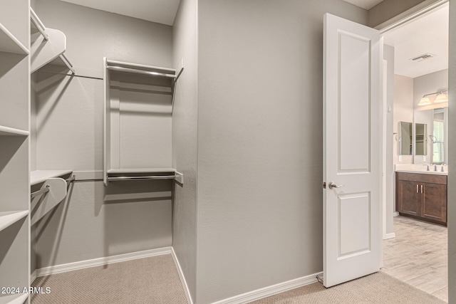 spacious closet featuring light hardwood / wood-style flooring