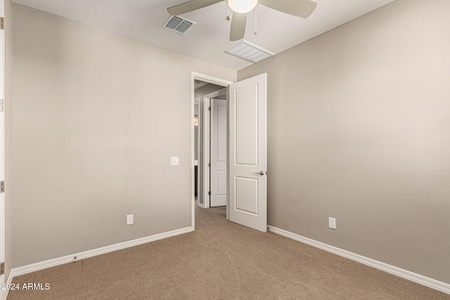 spare room with carpet floors and ceiling fan