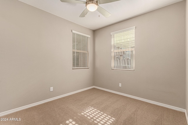 spare room featuring carpet floors and ceiling fan