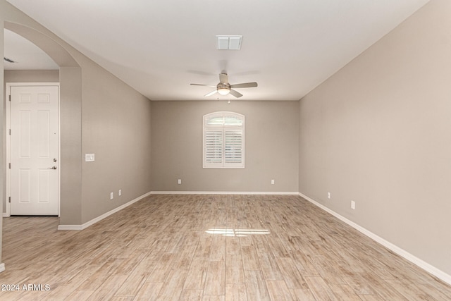 spare room featuring light hardwood / wood-style floors and ceiling fan