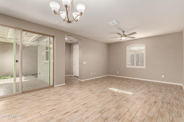 empty room with light hardwood / wood-style flooring and ceiling fan with notable chandelier