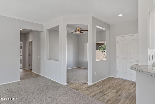 spare room featuring light wood-type flooring and ceiling fan