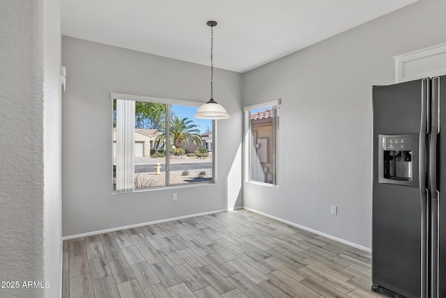 unfurnished dining area with light hardwood / wood-style flooring