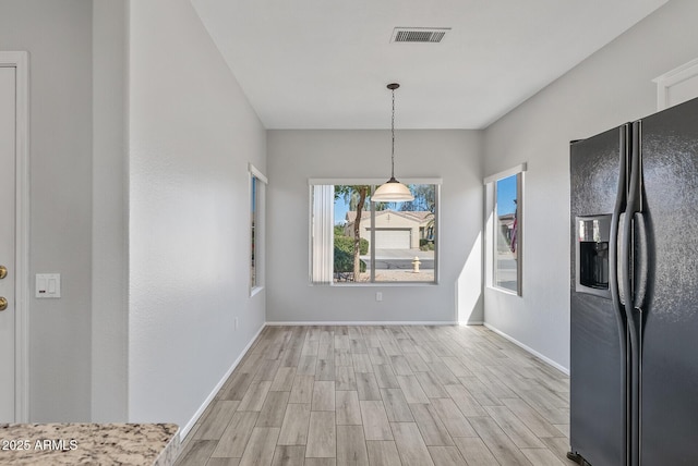 unfurnished dining area with light hardwood / wood-style floors