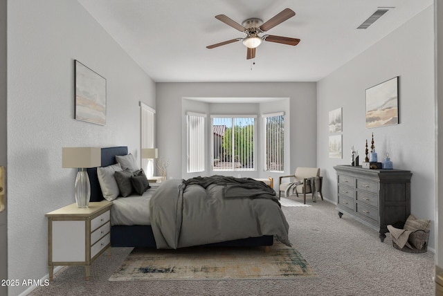 bedroom featuring ceiling fan and light carpet