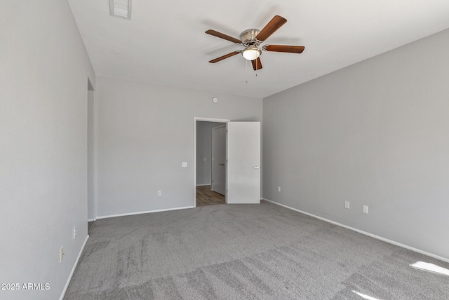 spare room with ceiling fan and carpet floors