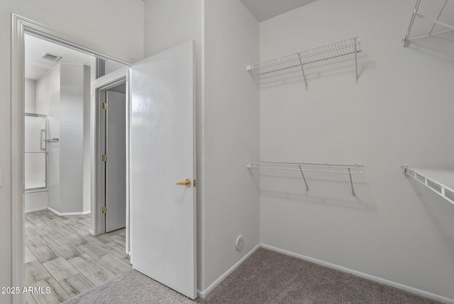 walk in closet with light wood-type flooring