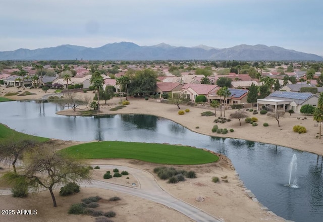 drone / aerial view featuring a water and mountain view