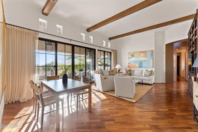 dining space with beam ceiling, visible vents, and wood finished floors