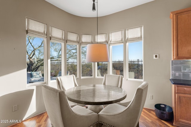 dining area with light wood-type flooring and a wealth of natural light