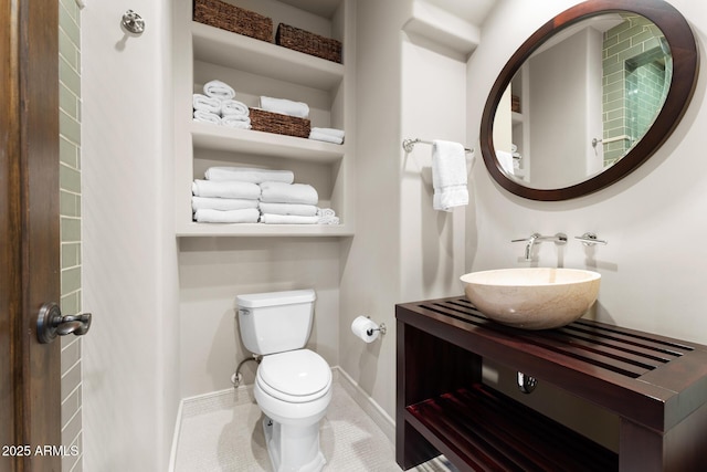 bathroom with baseboards, vanity, toilet, and tile patterned floors