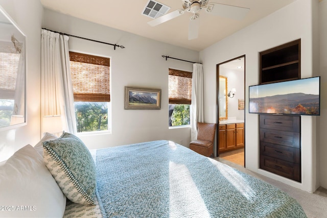 bedroom featuring light carpet, ceiling fan, connected bathroom, and visible vents