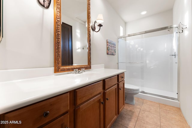 bathroom with a stall shower, vanity, toilet, and tile patterned floors