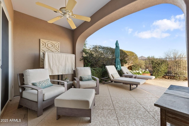 view of patio / terrace featuring fence and a ceiling fan