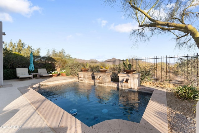 view of pool featuring a patio area and a fenced backyard