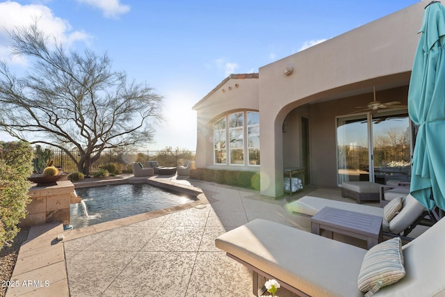 view of patio / terrace featuring a ceiling fan, an outdoor pool, outdoor lounge area, and fence