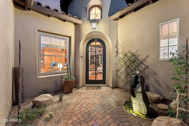 property entrance featuring stucco siding