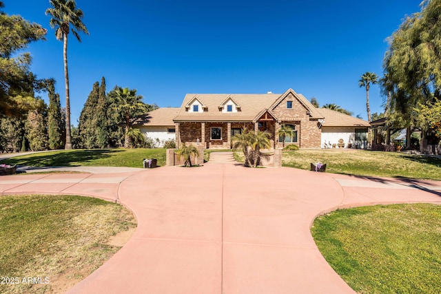25509 S Lime Dr, Queen Creek, AZ 85142 - view of front of home featuring brick siding, a front lawn, and curved driveway