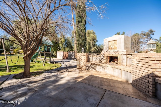 25509 S Lime Dr, Queen Creek, AZ 85142 - view of patio / terrace featuring a playground and an outdoor fireplace