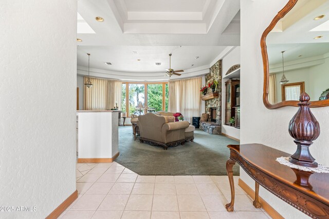 25509 S Lime Dr, Queen Creek, AZ 85142 - living area with baseboards, a textured wall, a fireplace, light tile patterned floors, and light colored carpet
