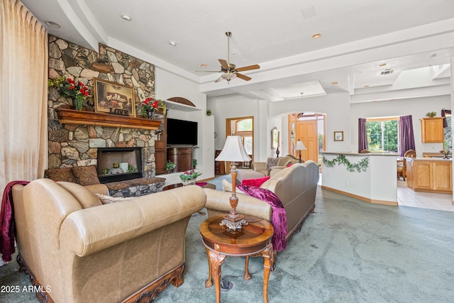 25509 S Lime Dr, Queen Creek, AZ 85142 - living area featuring a stone fireplace, a ceiling fan, arched walkways, and baseboards