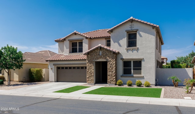 mediterranean / spanish home with a garage