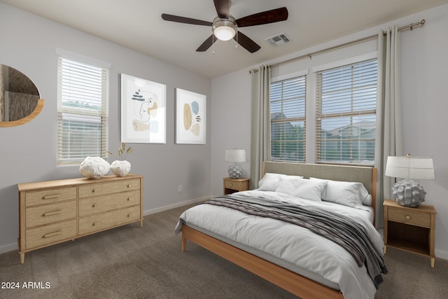 bedroom with ceiling fan and dark carpet