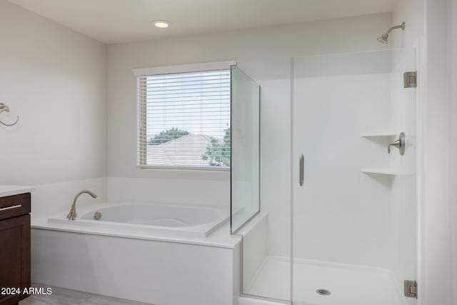 bathroom featuring vanity and shower with separate bathtub