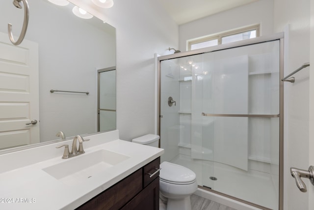 bathroom with vanity, toilet, and walk in shower