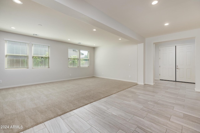 unfurnished room with light carpet