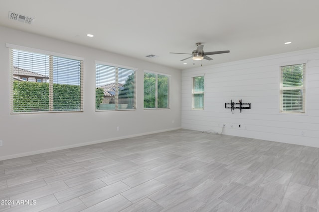 spare room featuring ceiling fan and light hardwood / wood-style floors