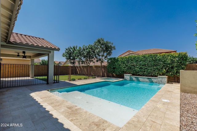 view of swimming pool featuring an in ground hot tub, ceiling fan, and a patio