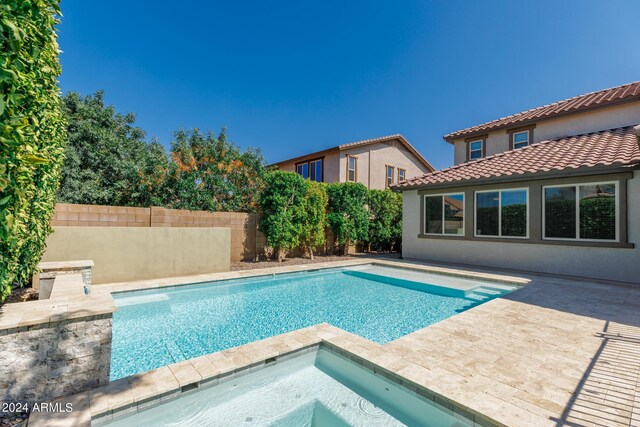 view of pool with an in ground hot tub