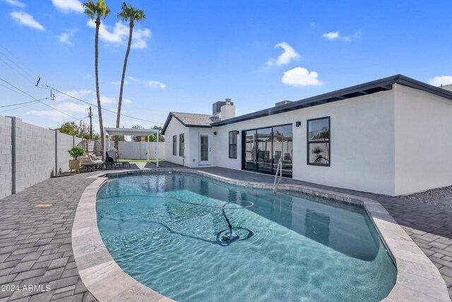 view of patio with a pergola, a fenced in pool, area for grilling, and grilling area