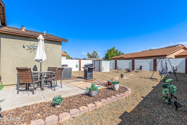 1950 E Dust Devil Dr, San Tan Valley, AZ 85143 - fenced backyard featuring a storage unit, a patio, an outdoor structure, and central AC unit