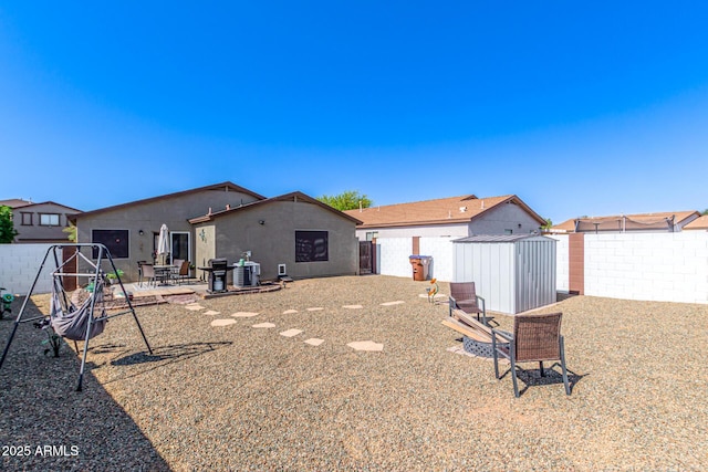 1950 E Dust Devil Dr, San Tan Valley, AZ 85143 - back of house with a storage unit, fence, a patio, and an outdoor structure