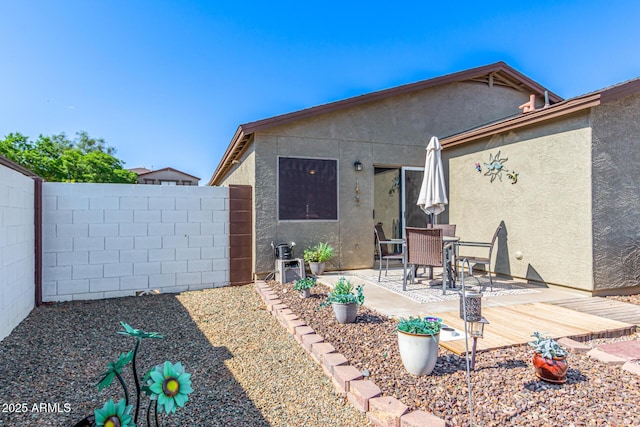 1950 E Dust Devil Dr, San Tan Valley, AZ 85143 - back of property with stucco siding, a fenced backyard, and a patio area