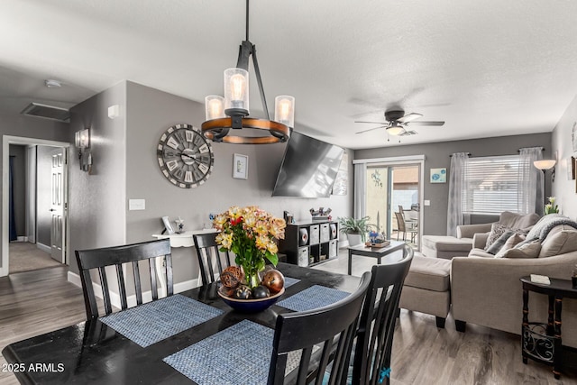 1950 E Dust Devil Dr, San Tan Valley, AZ 85143 - dining room with ceiling fan, wood finished floors, baseboards, and a textured ceiling