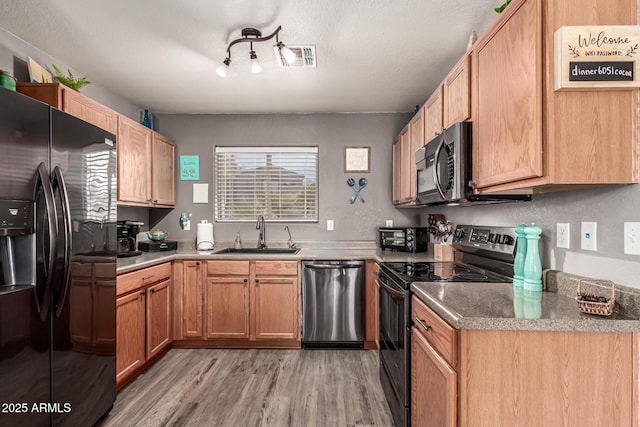 1950 E Dust Devil Dr, San Tan Valley, AZ 85143 - kitchen featuring black appliances, a sink, light wood finished floors, and rail lighting