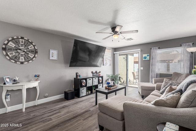 1950 E Dust Devil Dr, San Tan Valley, AZ 85143 - living room featuring ceiling fan, wood finished floors, baseboards, and a textured ceiling