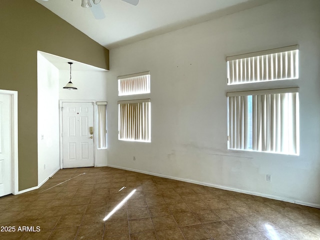 entrance foyer with high vaulted ceiling, baseboards, and a ceiling fan