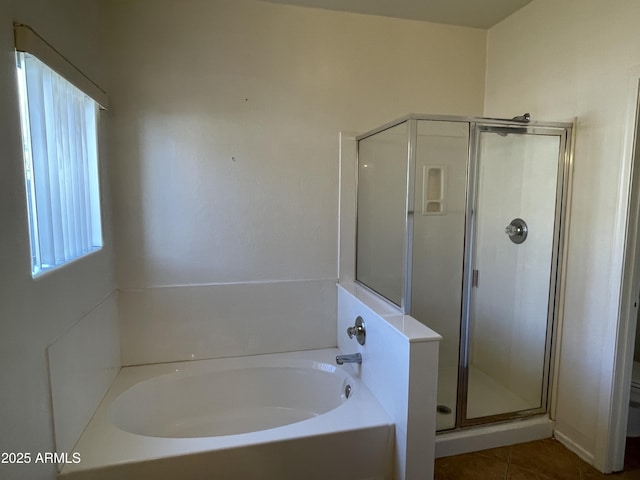 full bath featuring toilet, a stall shower, tile patterned flooring, and a bath