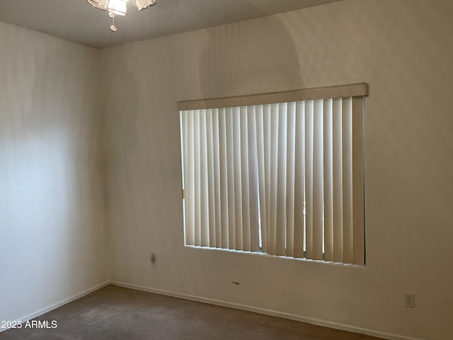 carpeted spare room with baseboards